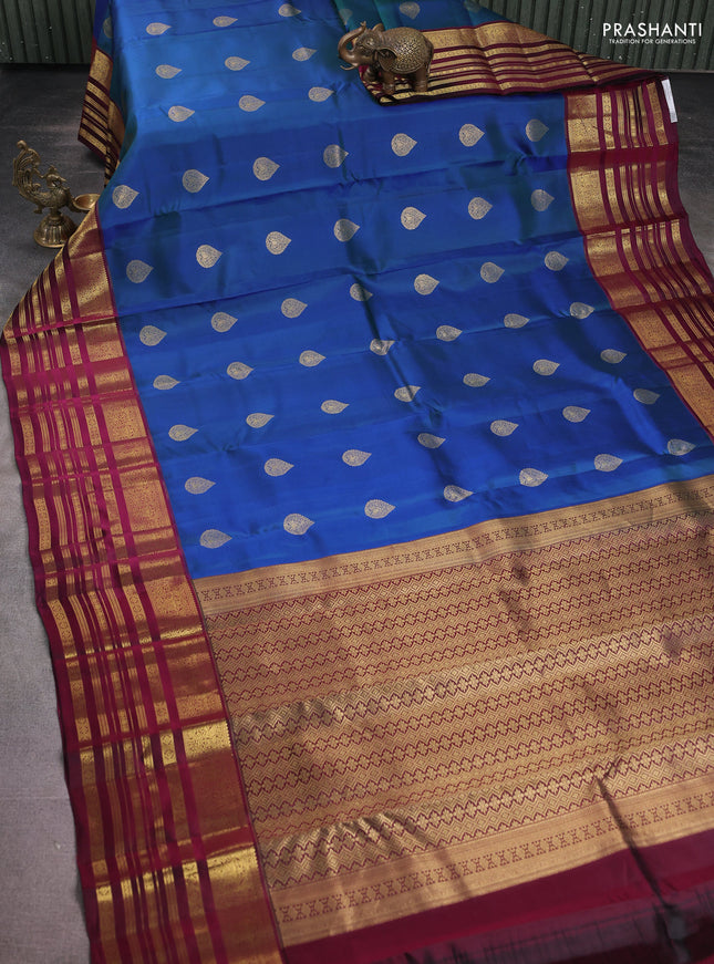Pure kanchipuram silk saree dual shade of bluish green and dark magenta pink with zari woven buttas and long zari woven border