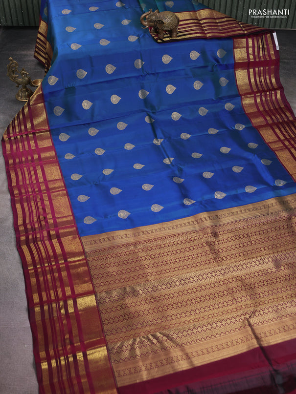 Pure kanchipuram silk saree dual shade of bluish green and dark magenta pink with zari woven buttas and long zari woven border