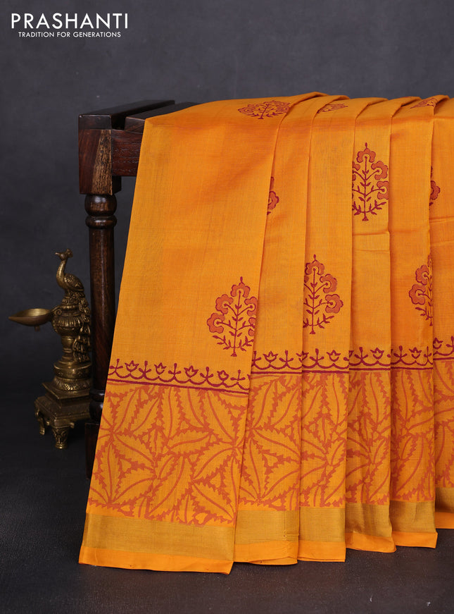 Silk cotton block printed saree mango yellow with butta prints and long printed zari woven border