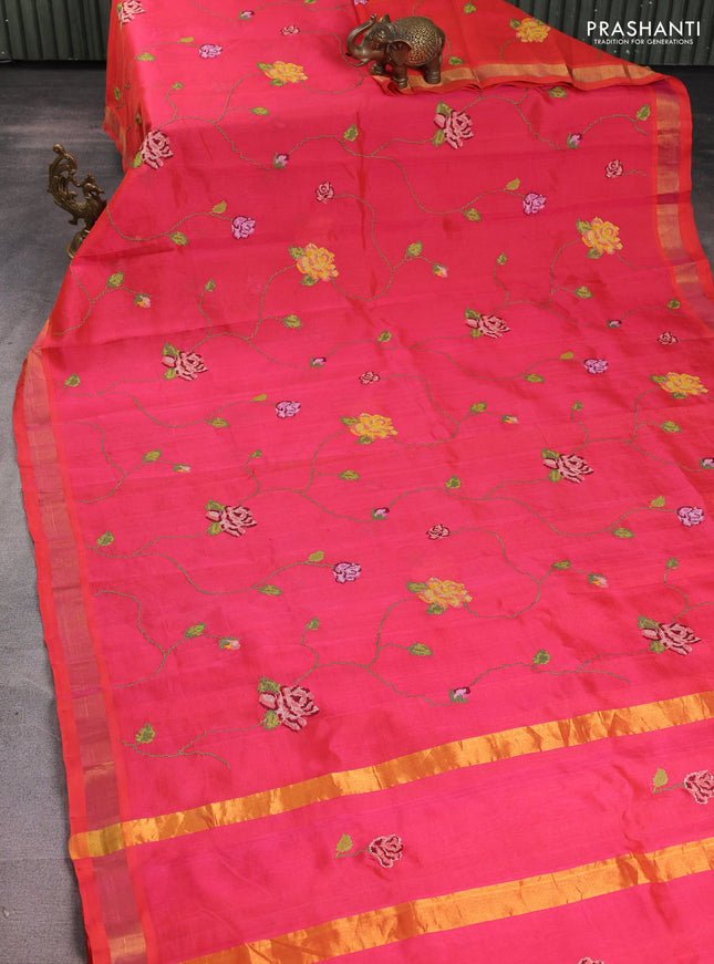 Silk cotton saree pinkish orange with allover floral embriodery and zari woven border