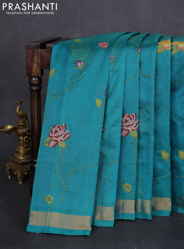 Silk cotton saree teal green with allover floral embriodery and zari woven border