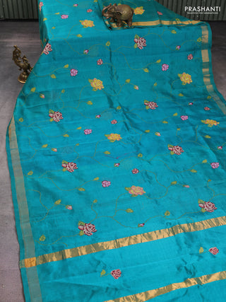 Silk cotton saree teal green with allover floral embriodery and zari woven border