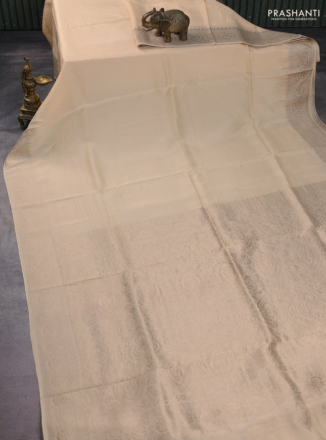 Dola silk saree cream with plain body and zari woven border