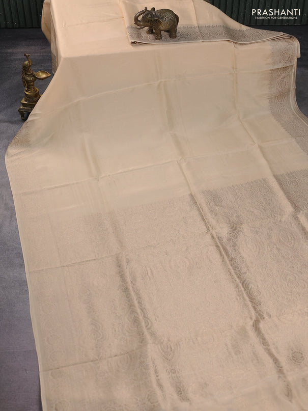 Dola silk saree cream with plain body and zari woven border