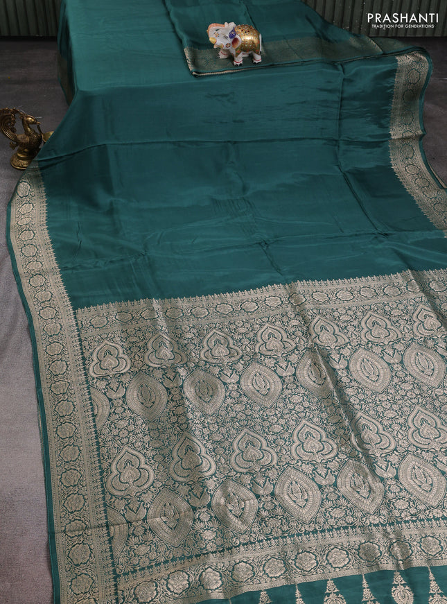 Dola silk saree peacock green shade with plain body and zari woven border