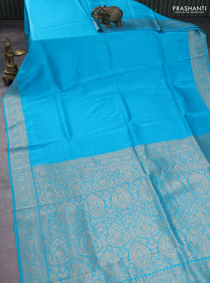Dola silk saree teal blue with plain body and zari woven border