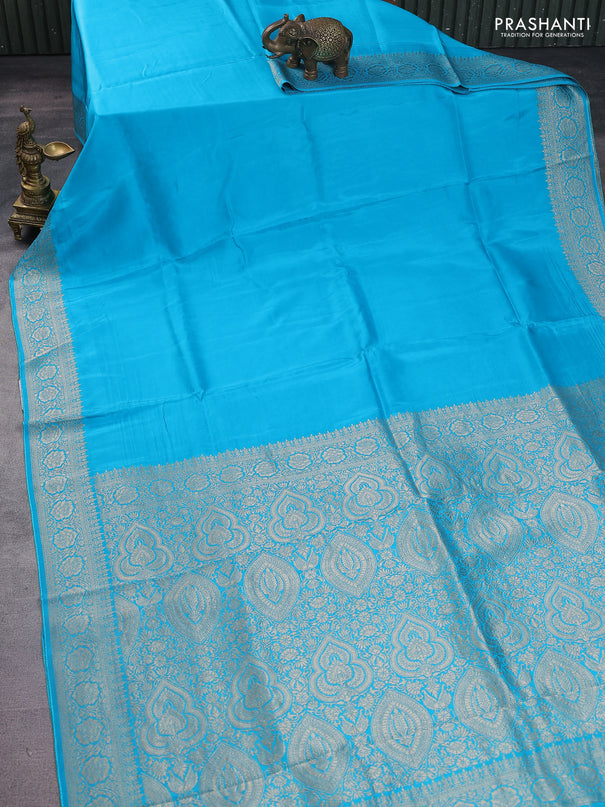 Dola silk saree teal blue with plain body and zari woven border