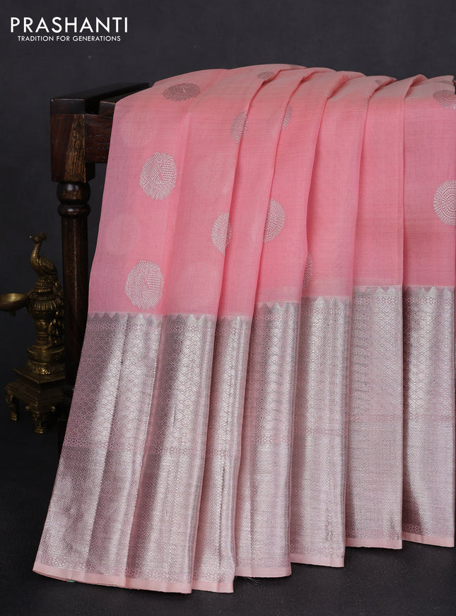 Kora kanchipuram silk saree peach pink and pastel peach with zari woven buttas and long silver zari woven border