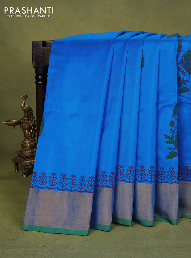 Uppada block printed silk saree cs blue and dual shade of blueish green with floral butta prints and zari woven border