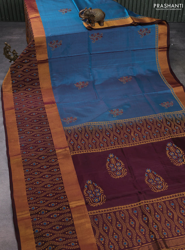 Uppada block printed silk saree peacock blue and brown with floral butta prints and long rettapet zari woven printed border