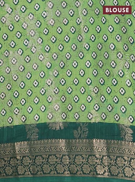 Semi dola saree bottle green with allover zari weaves & floral prints and zari woven border