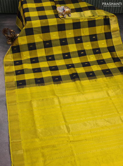 Silk cotton saree black and yellow with allover paalum pazhamum checks pattern & paisley zari buttas and zari woven border