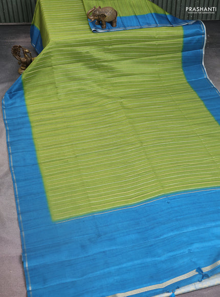 Semi tussar saree light green and peacock blue with allover silver & gold zari weaves and simple zari border