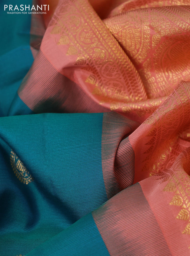 Pure gadwal silk saree dual shade of bluish green and peach shade with zari woven annam buttas and temple design zari woven border