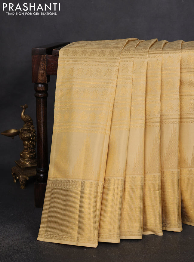 Pure kanchipuram silk saree pale yellow shade with allover zari woven brocade weaves and long temple design zari woven border