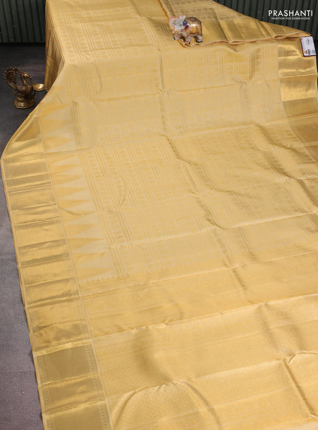 Pure kanchipuram silk saree pale yellow shade with allover zari woven brocade weaves and long temple design zari woven border
