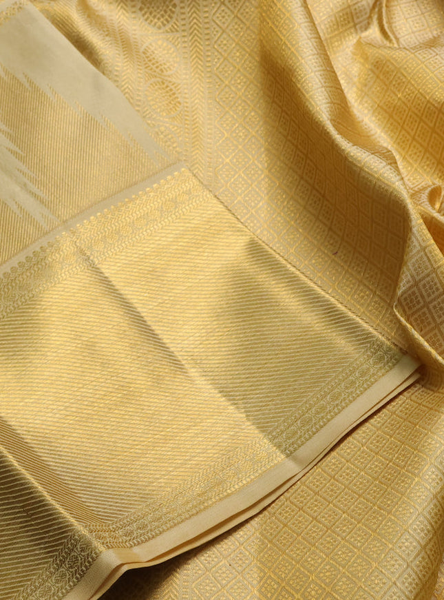 Pure kanchipuram silk saree pale yellow shade with allover zari woven brocade weaves and long temple design zari woven border