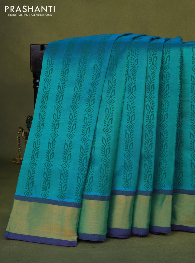 Silk cotton block printed saree dual shade of teal bluish green and violet with allover prints and zari woven border