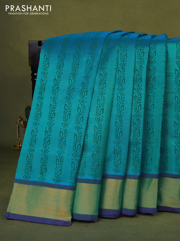 Silk cotton block printed saree dual shade of teal bluish green and violet with allover prints and zari woven border