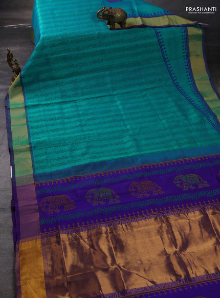 Silk cotton block printed saree dual shade of teal bluish green and violet with allover prints and zari woven border