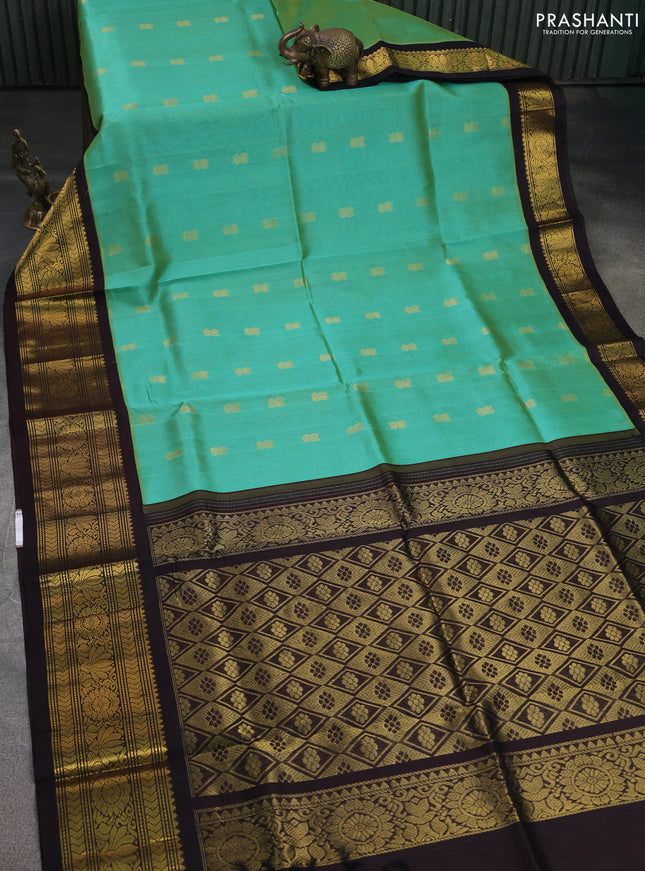 Silk cotton saree teal green and coffee brown with zari woven buttas and zari woven korvai border