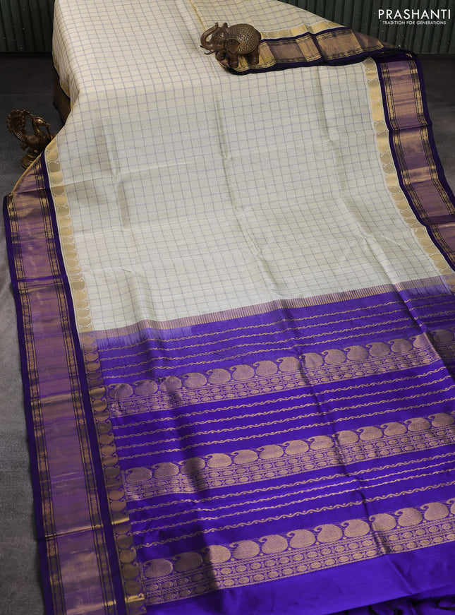 Silk cotton saree cream and blue with allover checked pattern and paisley rettapet zari woven korvai border