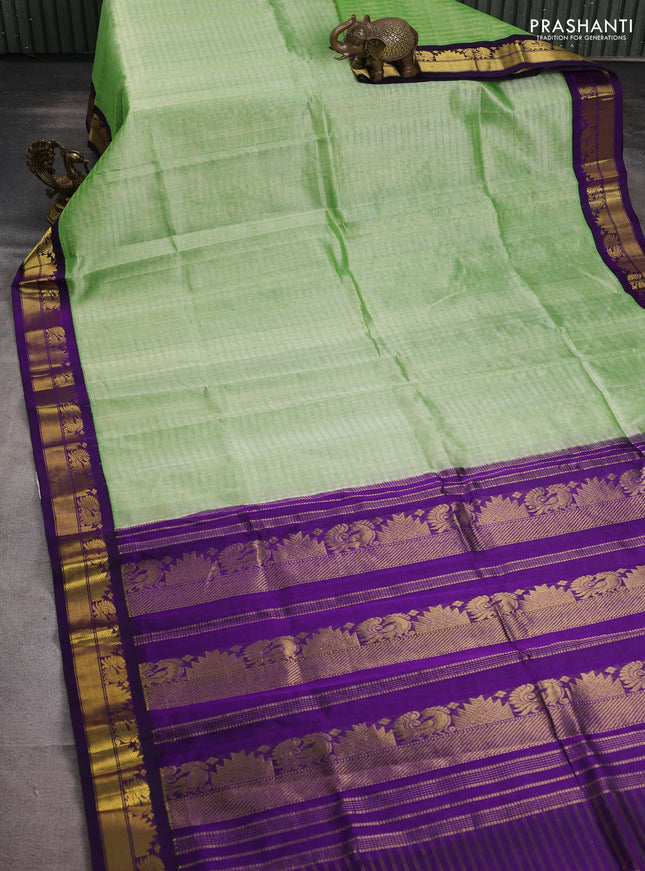 Silk cotton saree pista green and violet with allover zari woven checked pattern and zari woven korvai border