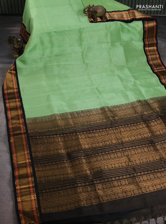 Silk cotton saree piata green and black with plain body and temple design zari woven border