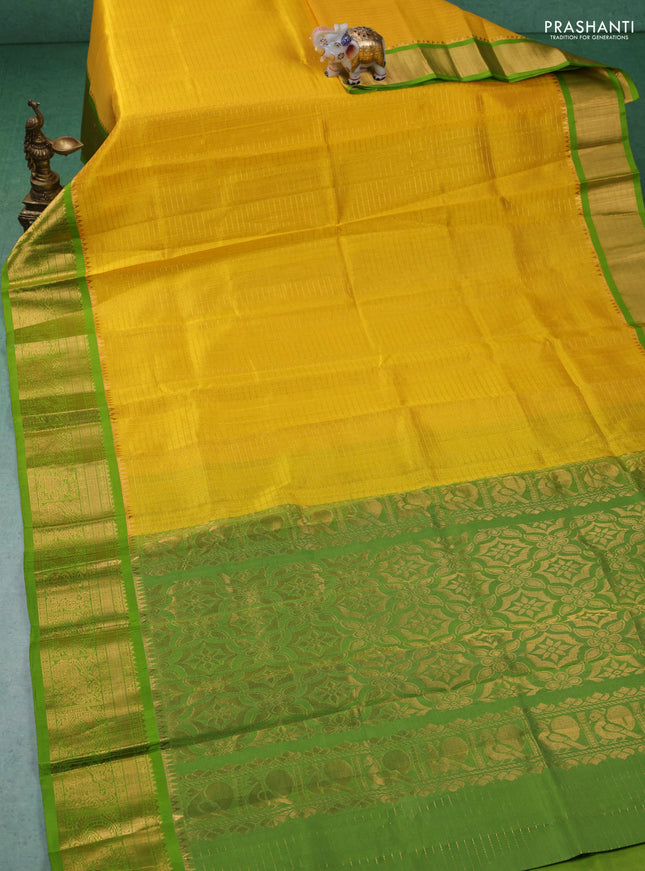 Kuppadam silk cotton saree yellow and light green with allover zari checks & lakshadeepam weaves and zari woven border