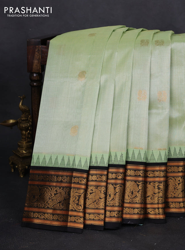Kuppadam silk cotton saree pista green and black with allover zari weaves & buttas with temple design zari woven border