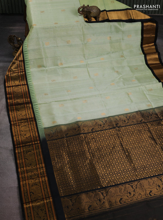 Kuppadam silk cotton saree pista green and black with allover zari weaves & buttas with temple design zari woven border