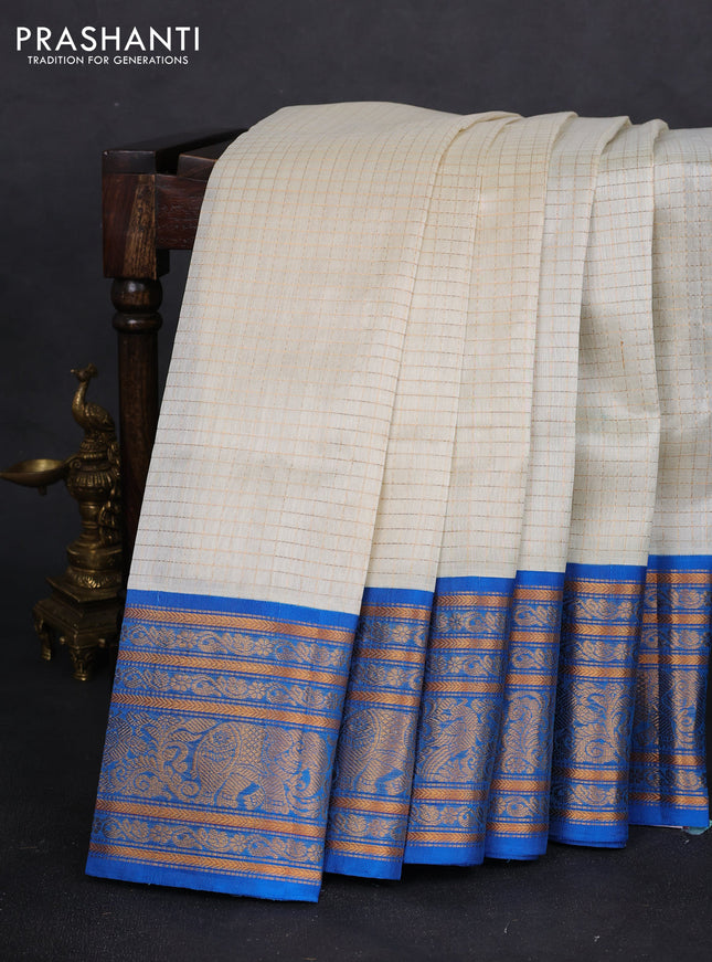 Kuppadam silk cotton saree off white and cs blue with allover zari checked pattern and long zari woven border