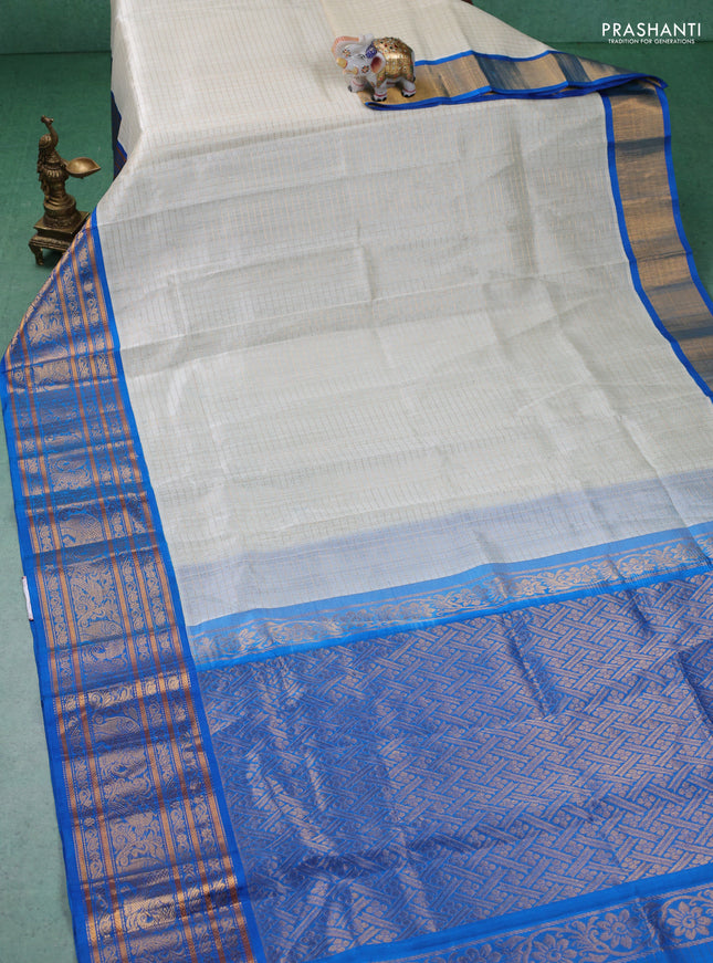 Kuppadam silk cotton saree off white and cs blue with allover zari checked pattern and long zari woven border