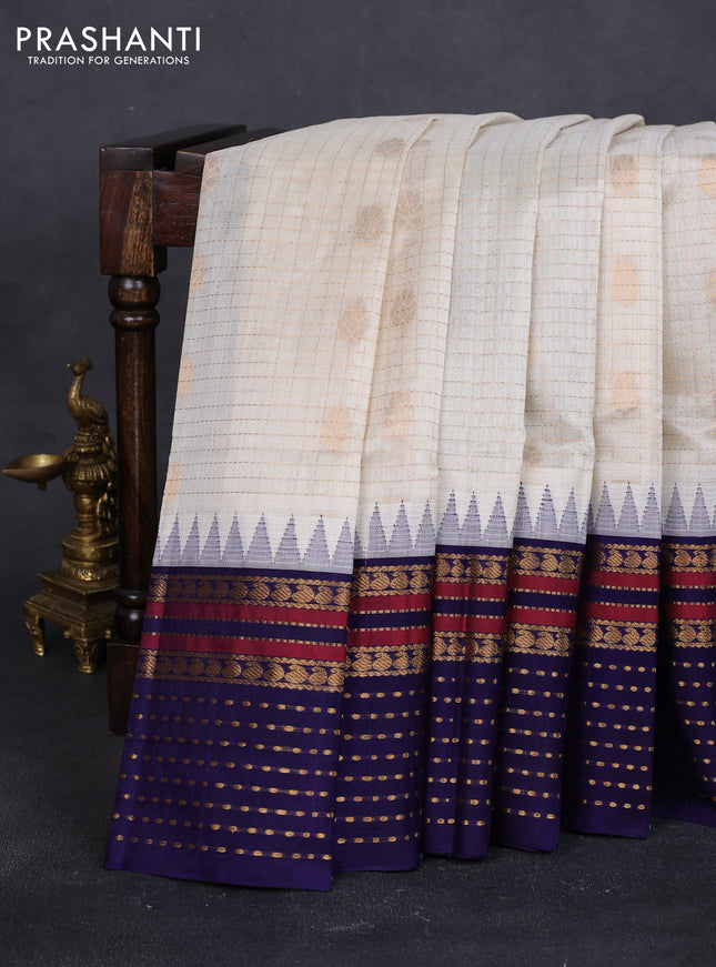 Kuppadam silk cotton saree off white and blue with zari checks & buttas and temple design zari woven border