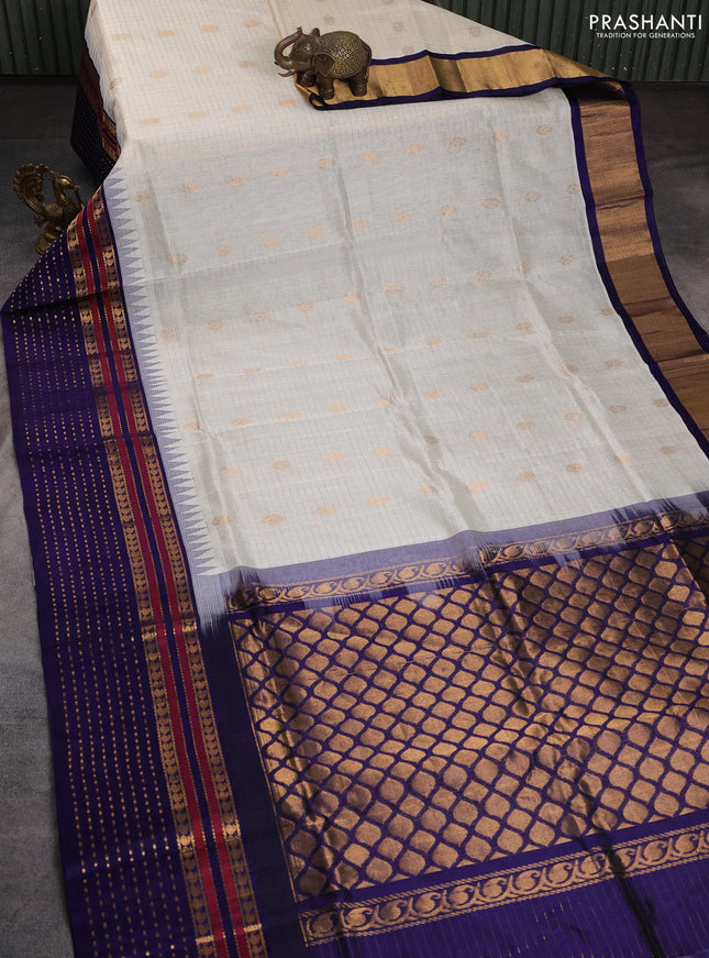 Kuppadam silk cotton saree off white and blue with zari checks & buttas and temple design zari woven border