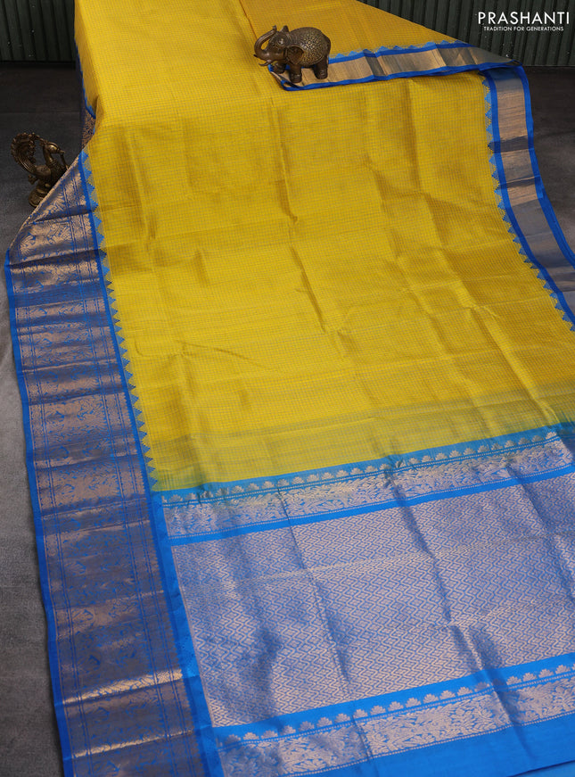 Kuppadam silk cotton saree yellow and cs blue with allover small checked pattern and long zari woven border