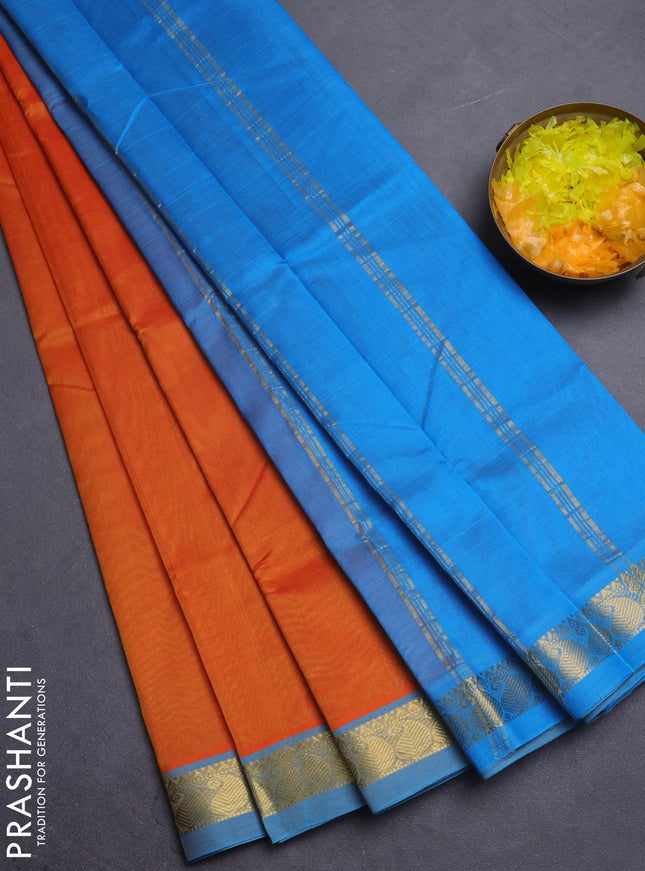 Silk cotton saree sunset orange and cs blue with plain body and paisley zari woven border