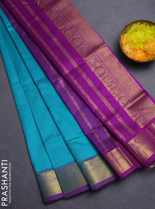 Silk cotton saree teal blue and violet with plain body and zari woven border