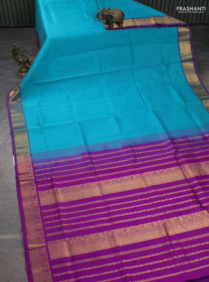 Silk cotton saree teal blue and violet with plain body and zari woven border