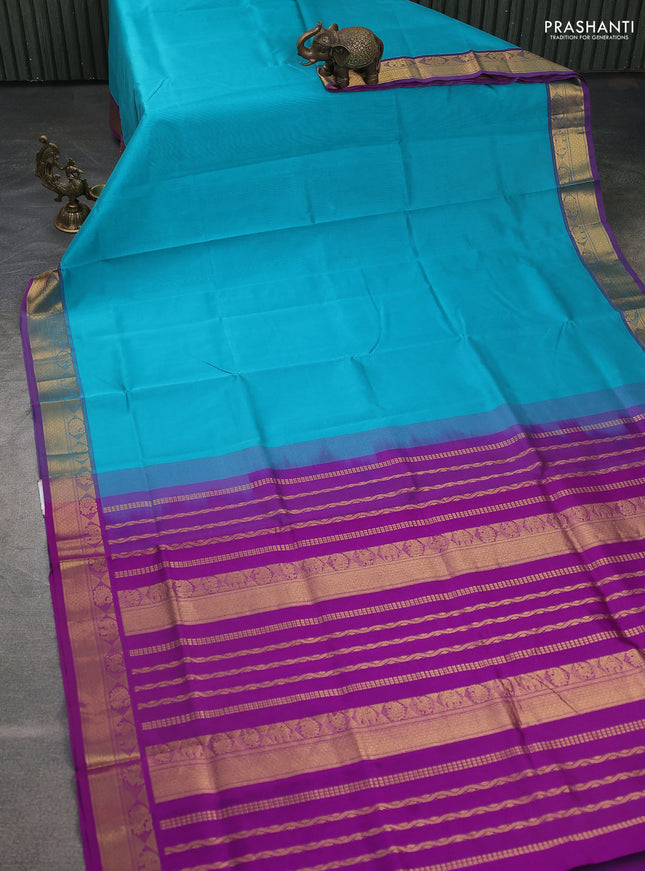Silk cotton saree teal blue and violet with plain body and zari woven border