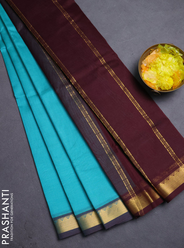 Silk cotton saree teal blue and deep maroon with plain body and zari woven border
