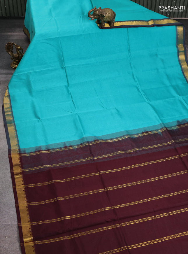 Silk cotton saree teal blue and deep maroon with plain body and zari woven border