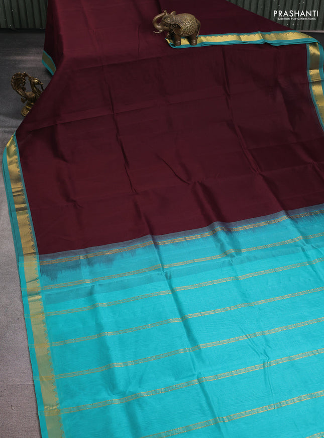 Silk cotton saree deep maroon and teal green with plain body and zari woven border