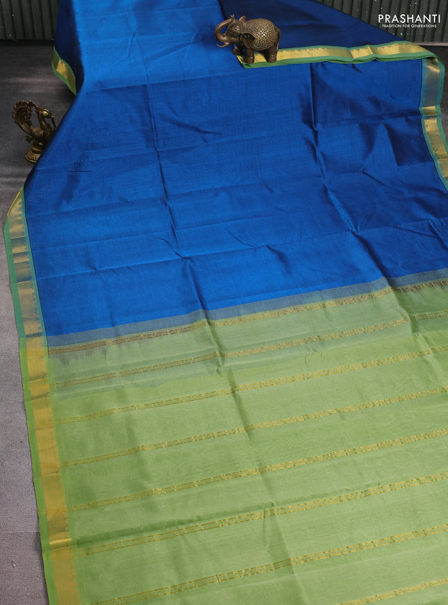 Silk cotton saree peacock blue and pastel green with plain body and zari woven border