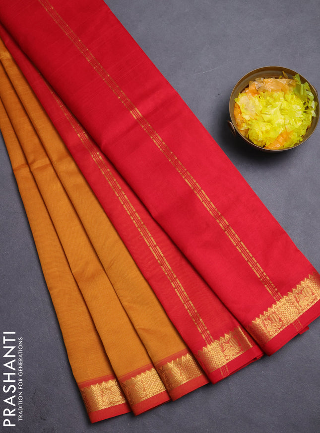 Silk cotton saree dark mustard and red with plain body and zari woven border