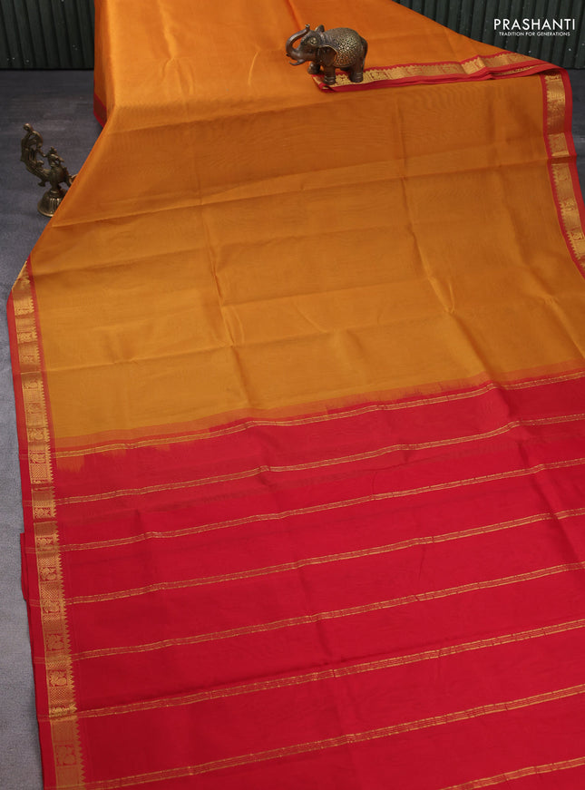 Silk cotton saree dark mustard and red with plain body and zari woven border