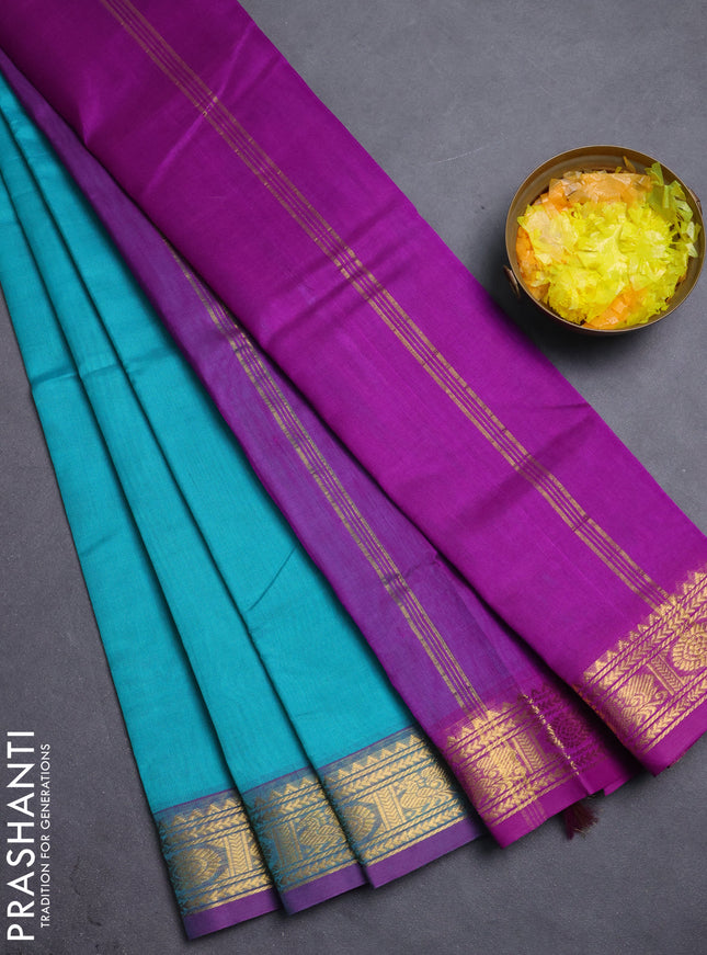 Silk cotton saree teal blue and purple with plain body and peacock zari woven border