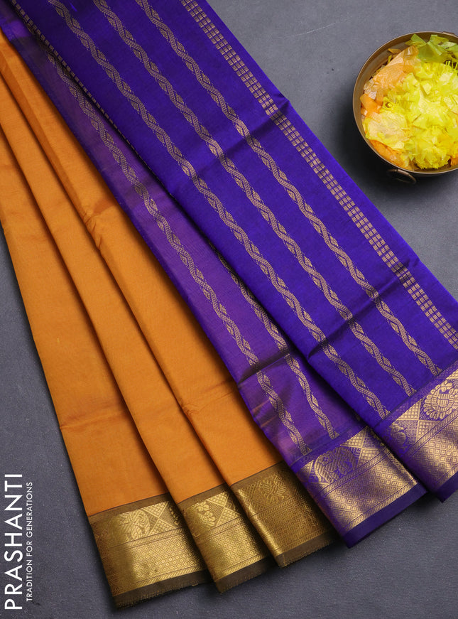 Silk cotton saree dark mustard and blue with plain body and zari woven border