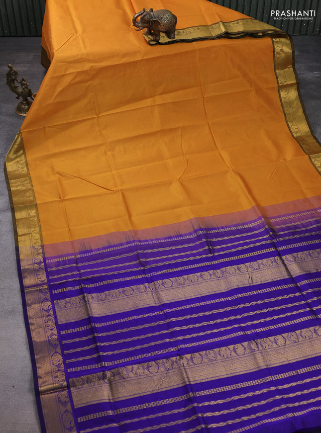 Silk cotton saree dark mustard and blue with plain body and zari woven border