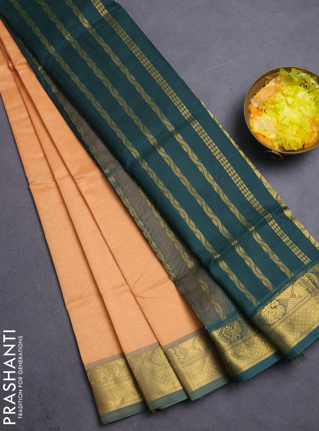 Silk cotton saree pale orange and bottle green with plain body and zari woven border